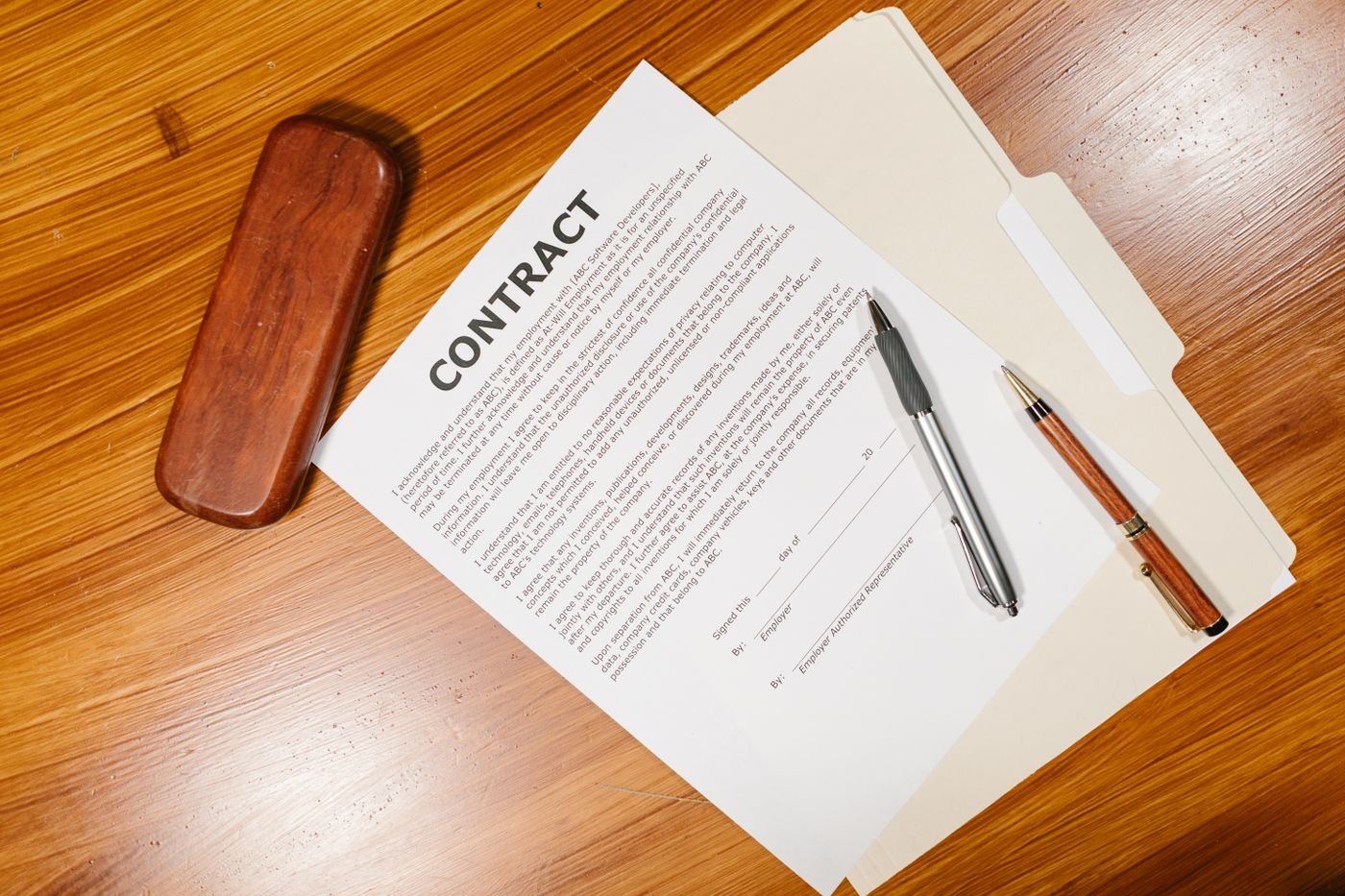 Documento de contrato de trabajo y útiles de escritorio sobre una mesa